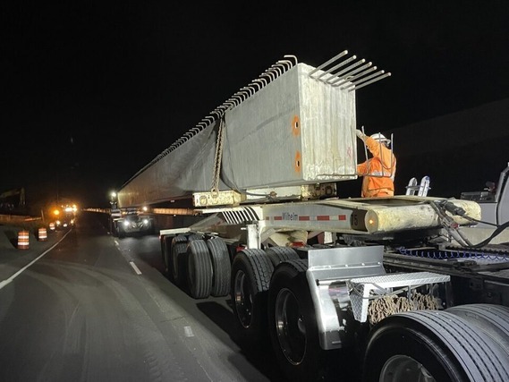 Concrete box beam being delivered to the work zone.