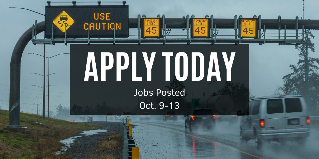 Photo of use cation and advisory speed signs over a rainy highway with traffic going by.