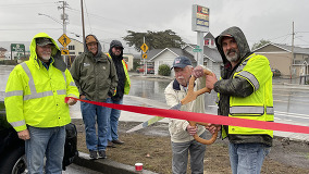 Former Seaside Mayor Jay Barber (with scissors on left) and Area 1 Manager Bill Jablonski prepare to cut the ribbon 