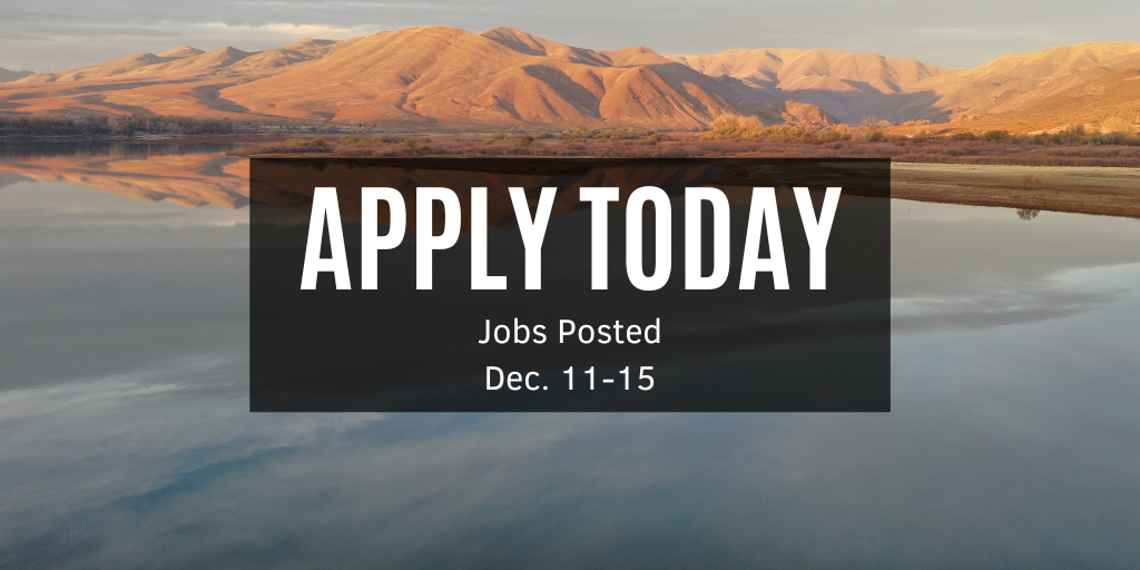 Photo overlooking a large body of water with rolling hills in the background. 