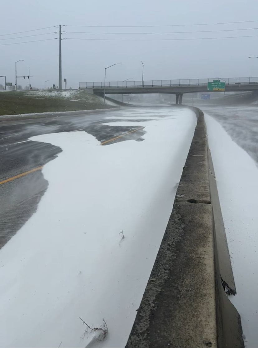 Drifting snow piles up along the center barrier of Interstate 84 in Portland on Saturday.