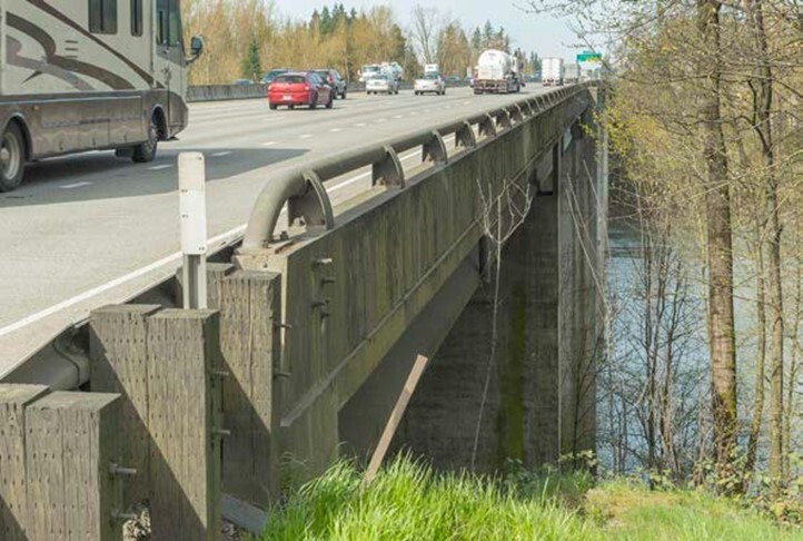 A photo of cars and trucks driving on I-5 across the Boone Bridge. 