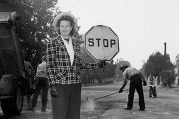 A woman flags road work circa 1940s.