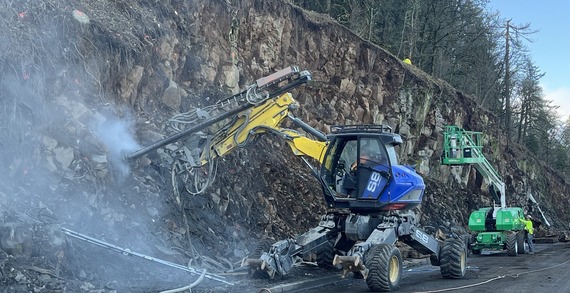 photo of anchors being drilled into hillside