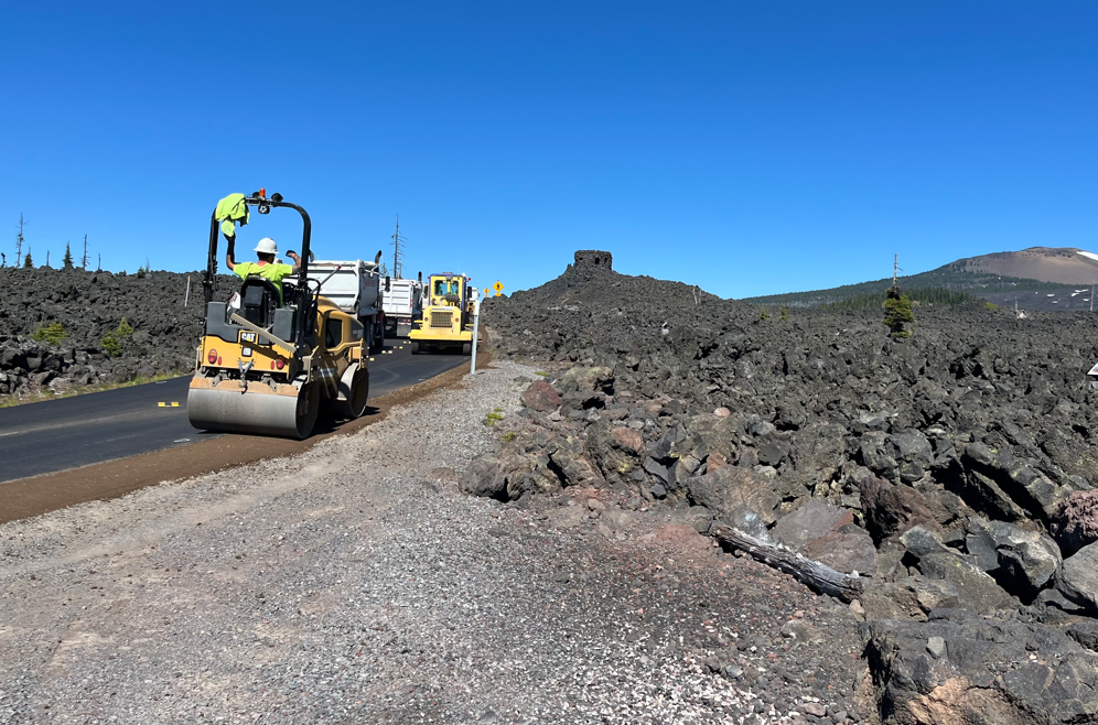 Crews pave near the summit of McKenzie Pass.