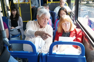 Oregon Transportation Commission Vice Chair Lee Beyer and Representative Susan McLain talk on bus during Eugene tour