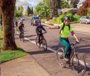 People riding bicycles in a bike lane in a school zone