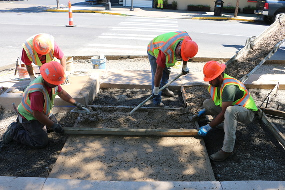 Photo of workers making a curb ramp ADA compliant