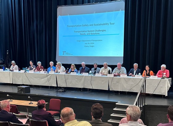 State legislators on Joint Committee on Transportation on stage at public hearing in Albany, Oregon