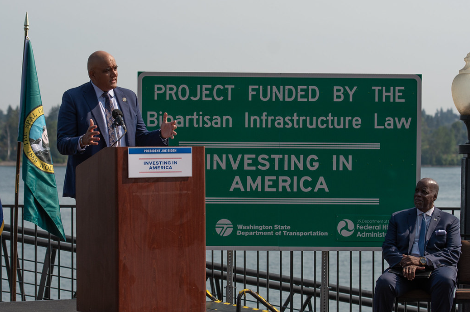 Federal Highway Administrator Shailen Bhatt, shown above speaking, with IBR Program Administrator Greg Johnson at right.