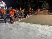 workers paving a bridge surface