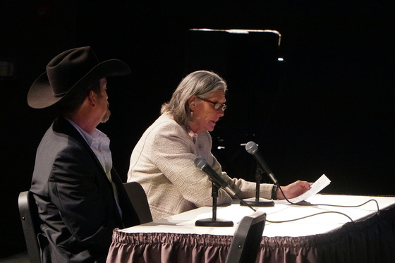 Two members of the public sit at a table to provide public testimony at the Ontario legislative public hearing.