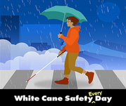 Woman walking with umbrella in the rain in crosswalk with white cane