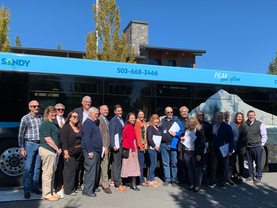 Group photo in front of bus