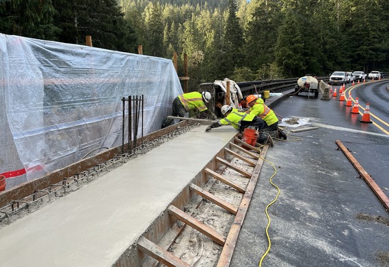 Photo of workers leveling cement on sidewalk