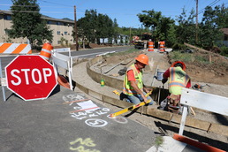 Photo of construction workers on a curb ramp project