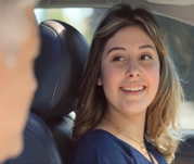 Driver education student in a vehicle smiling