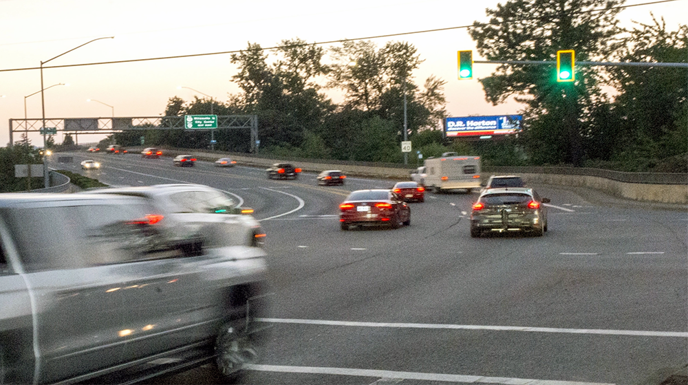 Traffic signal at intersection with vehicles