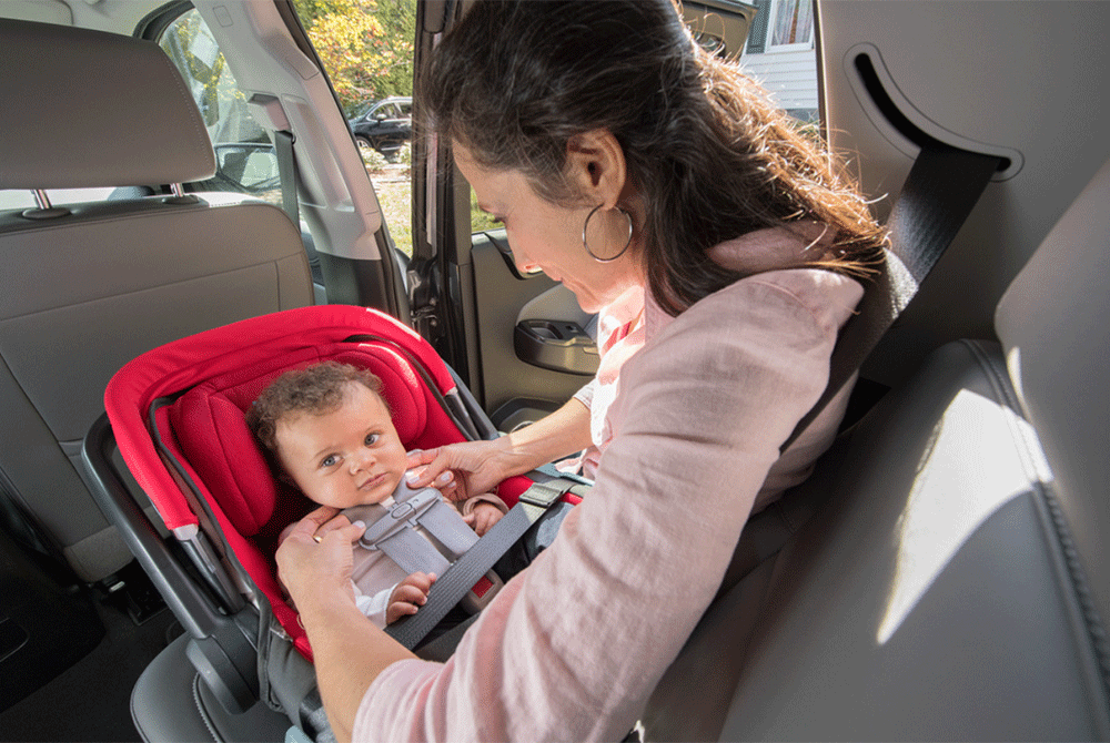 Woman installing child car seat
