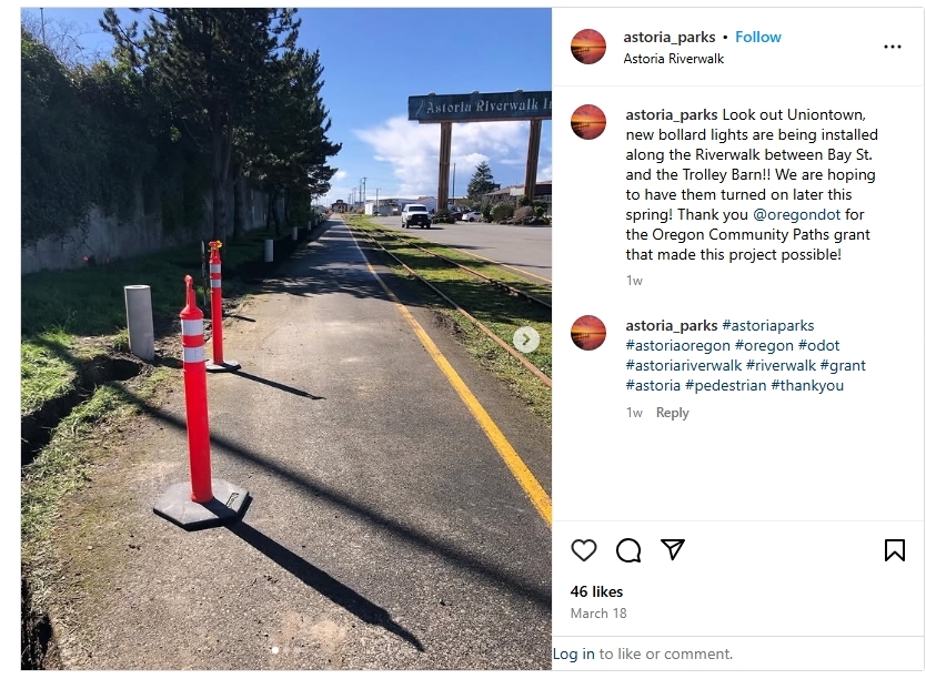 Screenshot of Instagram post showing a sidewalk with orange safety posts next to a road