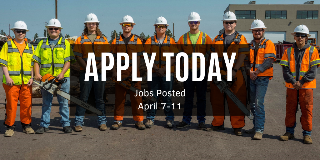 Youth training program trainees holding equipment in safety gear.