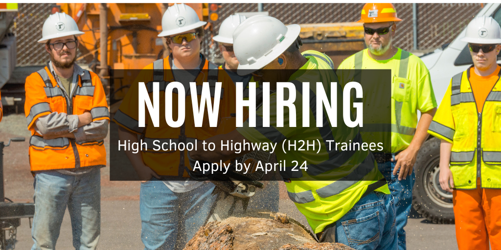 Employees watching instructor demonstrate using a chainsaw