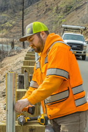 Photo showing crew member installing guardrail