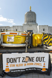 A truck that has been hit sits in front of the State Capitol building in Salem.