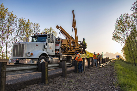 Photo showing crews installing guardrail
