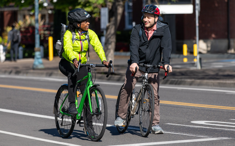 two people on bikes in a street