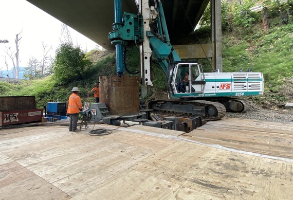 Map above shows crews drilling new support shafts while standing on the temporary work structure beneath the highway.