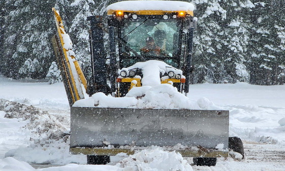 Crews clear snow from the highway near Diamond Lake.