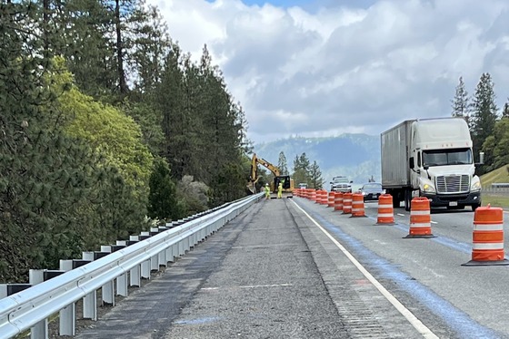 Traffic flows in one lane on I-5 north of Grants Pass while crews install guardrails.
