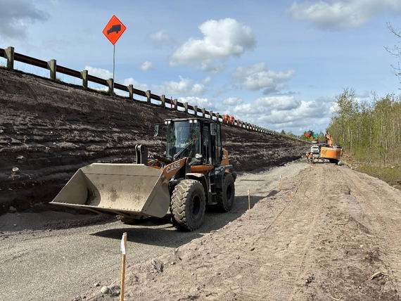 View of crews hauling out rock and pushing material down to grade at Jordan Road.