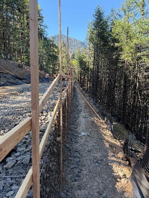 View of the beginning stages of construction to form the new retaining wall, being built along the future trail.