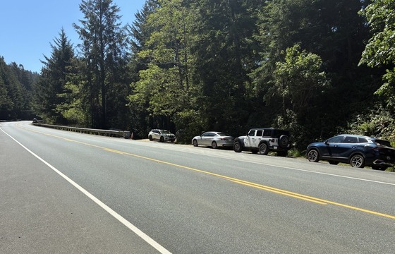 Vehicles parked in undeveloped parking area on U.S. 101