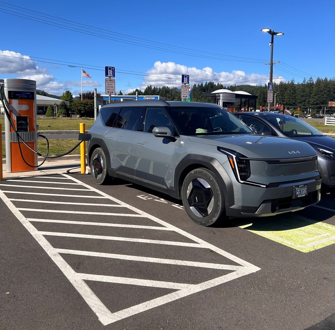 An electric vehicle charging at a public EV charging station.