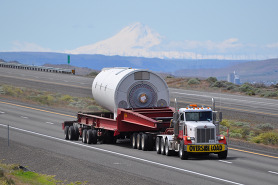 Oversize load on a road with mountain in background