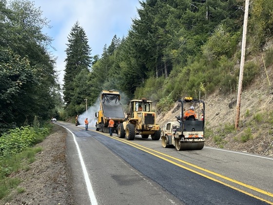 Maintenance crews paving ruts, potholes and cracks.
