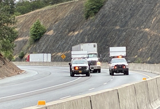 ODOT pilot cars lead a semi-truck through the work zone.