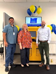L to R: Jonah Kopp, Karrie Wilson, David McKay in front of new kiosk