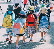 children walking with backpacks