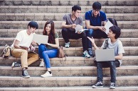 Students sit on stairs while studying
