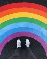 Sidewalk rainbow with two standing feet