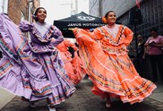 two women in colorful dresses dancing
