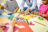children making art with paper at a table