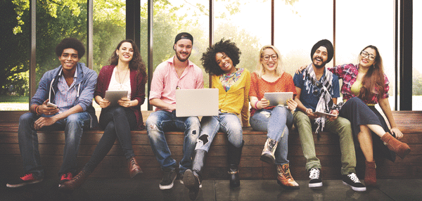 picture of college students sitting outside with laptops