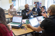 educators collaborating with laptops