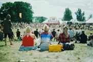 audience sitting facing a festival stage