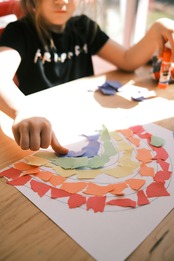 Student with rainbow colored cutouts